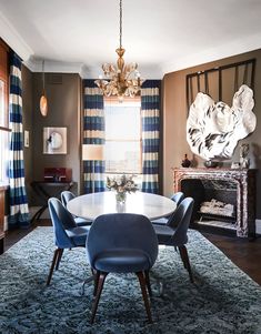 a dining room table with blue chairs around it