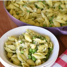 pasta with peas and parmesan cheese in a bowl next to a casserole dish