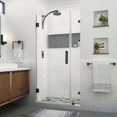 a bathroom with a shower, sink and mirror