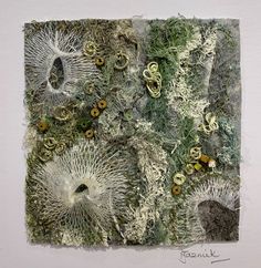 an art work with various types of plants and buttons attached to it's surface