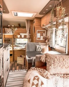 the inside of a camper with lots of furniture and decor on it's walls