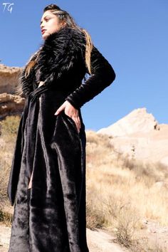 "Women's Empress Coat Make a daring statement in this stylish, sophisticated Empress Faux Fur coat on the Playa, at a festival or a night out on the town! The fitted Furrocious Empress coat is lined with the softest plush velour. The contrast detachable fur shawl collar makes this coat extra cozy to wear. The coat is cinched at the waist with a self tie belt. The long length and slim cut fit give this coat a glamorous feel. The Empress coat is hand made with superior quality in the USA. EMPRESS Luxury Black Elegant Fur Coat, Luxury Long Black Fur Coat, Festival Coats, Luxury Black Fluffy Fur Coat, Sequin Vest, Side Belt, Winter Fur Coats, Long Mink-colored Faux Fur Coat, Luxury Winter