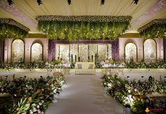 an indoor wedding setup with flowers and greenery