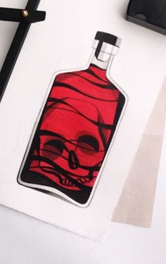 a drawing of a red skull in a glass bottle on top of a white paper