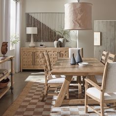 a dining room table and chairs in front of a large window with a checkered rug on the floor