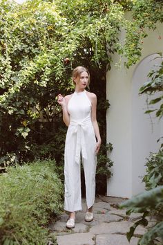 Looking for a comfortable and stylish jumpsuit that's perfect for a sunny day out? Our linen jumpsuit with halter neck and long pants is the perfect addition to your wardrobe. This versatile and chic garment is perfect for a range of occasions, from a day out in the city to a beachside vacation. Crafted from high-quality linen, this jumpsuit feels comfortable and lightweight against the skin, making it perfect for warm weather. The halter neck provides a flattering and feminine look, while the l Elegant Strapless Halter Neck Jumpsuit For Spring, Elegant Halter Neck Strapless Jumpsuit For Spring, Summer White Backless Jumpsuits And Rompers, White Backless Jumpsuits And Rompers For Day Out, White Backless Jumpsuit For Summer, Elegant Strapless One-piece Jumpsuit For Summer, Chic Sleeveless Jumpsuits And Rompers For Wedding, Elegant Sleeveless Jumpsuits And Rompers For Summer, Chic Sleeveless Jumpsuit For Wedding