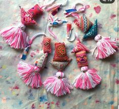 several different types of tassels are laid out on a tablecloth with sprinkles and confetti