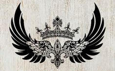 an ornate crown with wings on a wooden background