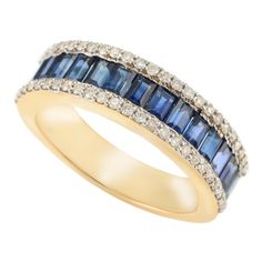 an 18k gold ring with blue and white sapphires set in the center, surrounded by brilliant pave diamonds