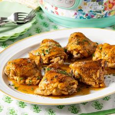 some chicken is sitting on a plate with gravy in front of an instant pressure cooker