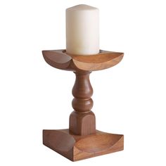 a wooden candle holder with a white candle on it's side and a wood base