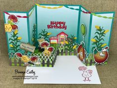 a birthday card with chickens and farm scenes on the front, in an open fold