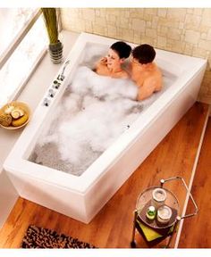 two people are sitting in the bathtub