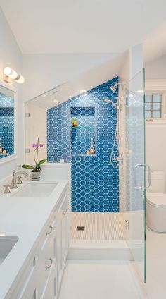 a bathroom with blue and white tiles on the walls