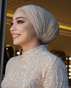 a mannequin wearing a white dress with silver sequins on it's head