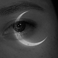 a person's eye is shown with the moon in the middle of their iris