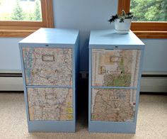 two blue drawers with maps on them sitting next to each other in front of a window