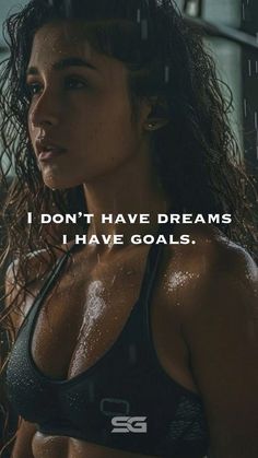 a woman in a sports bra top with the words i don't have dreams, i have goals