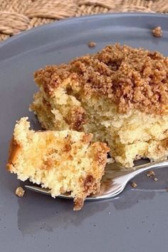 a piece of cake on a blue plate with a fork in front of it and a bite taken out