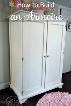 a white armoire with flowers on top and pink rug in the corner next to it