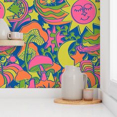 a colorful wallpaper with an abstract design on the walls and vases next to it