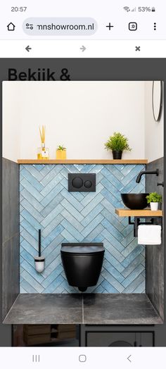 the bathroom is decorated in black and blue tones, with an interesting pattern on the wall