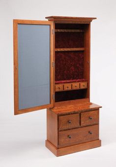 a wooden cabinet with drawers and a mirror