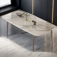 a white marble dining table with two vases on the top and one flower in front of it