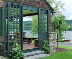 an open patio door to a house next to a body of water