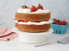 there is a cake with strawberries on top