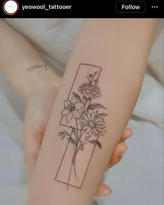 a woman's arm with flowers in a vase tattoo on the left side of her arm