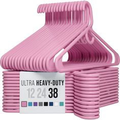 pink plastic hangers stacked on top of each other in front of a white background