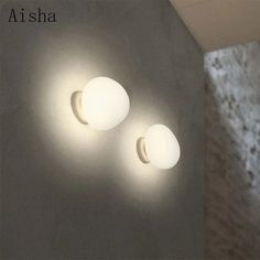 two white lights are on the wall next to each other