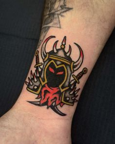 a man's arm with a tattoo on it that has an image of a demon and two swords