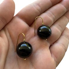 This is a pair of 18K gold round black onyx drop earrings  .The diameter of each onyx is 18 mm. The weight of the earrings is about 16.8 gr with the onyx .  Here is some details of the item: Gold-Glossy finish-Onyx-Hand made-18K Hallmarked  Here is some informations about gold carat: There are several carats available for gold. The carat is the gold content of the metal. The carat measures the proportion of pure gold mixed with other metal alloy to make up the final metal. The carat of gold is r Black Drop Earrings, Black Onyx Earrings, Onyx Earrings, Pure Gold, Making Jewelry, Black Onyx, Jewelry Earrings Dangle, Onyx, Really Cool Stuff