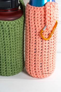 two crocheted water bottles sitting next to each other