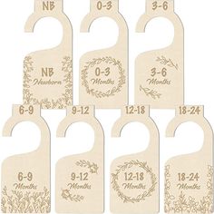 six wooden door hangers with numbers and floral designs on the front, one for each month