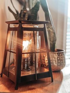 an old fashioned lantern is sitting on a table