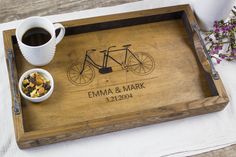 a personalized wooden tray with a bike and bowl of cereal on it next to a cup of coffee