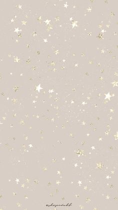 a white and gold wallpaper with stars on the bottom right hand corner in light grey