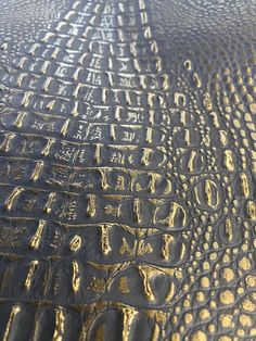 the surface of an alligator skin with gold paint