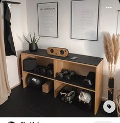 there is a black and white photo on the wall next to a shelf with various items