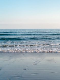 an ocean view with waves coming in to shore