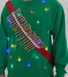 a man wearing a green christmas sweater with lights on it and a red tie around his neck