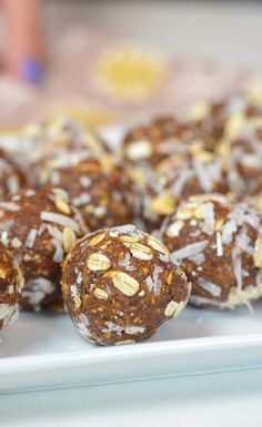 there are many balls of food on the plate and one is covered in coconut flakes