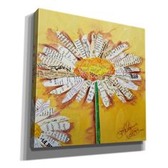 a yellow and white flower made out of old book pages on an acrylic canvas