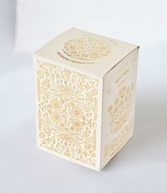 a white box with gold designs on it