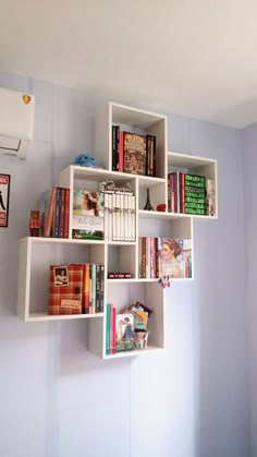 a white shelf with books on it in a room