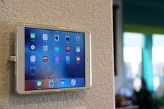 an ipad mounted to the side of a wall