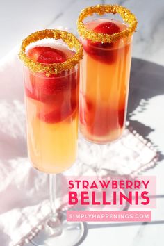 two glasses filled with strawberry bellini sitting on top of a white table next to each other